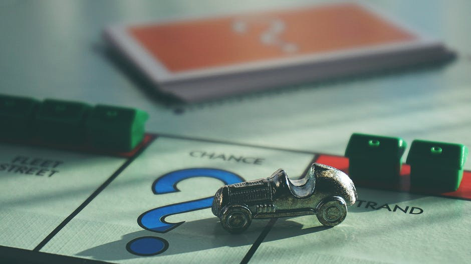 monopoly board with car on chance space