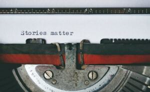 old typewriter with the words stories matter typed on it