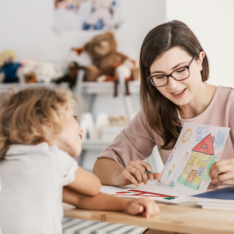 teacher sharing a picture book with a child